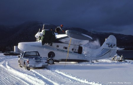 Cleaning snow off Westflight Aviation Grumman Goose