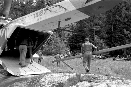 Crew unloading lumber from helicopter