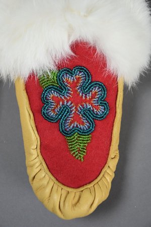 Beaded moccasins with blue flower design detail