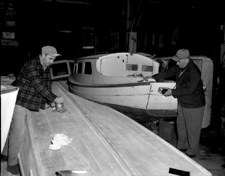 Working on boats in a cannery building, March 1953