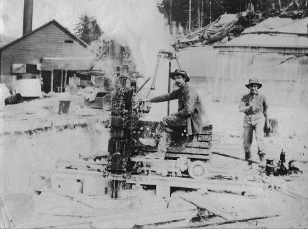 Rollin Bissette (seated) and Willie Wallace adjust the angle of the rails.