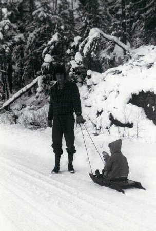 Lloyd Turner with his daughter, Marie, on a similar sled on Ward Lake Road.